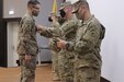 Sergeant Major Alex Young pins Joseph Nowak to Staff Sergeant at Joint Training Center in Jordan on January 28 2021. Staff Sgt. Nowak provides mobility support and accountability to all units to facilitate personnel and equipment onward movement and integration within Jordan.