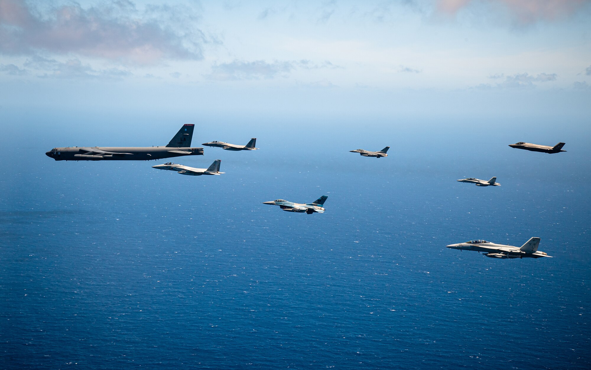 An 8-ship joint-coalition formation flies over Guam during exercise Cope North 21, near Andersen Air Force Base, Feb. 9, 2021.  Cope North is an annual exercise that serves as a keystone event to enhance U.S. relations with our regional allies and partners by demonstrating our resolve to promote security and stability throughout the Indo-Pacific.  (U.S. Air Force photo by Senior Airman Duncan C. Bevan)