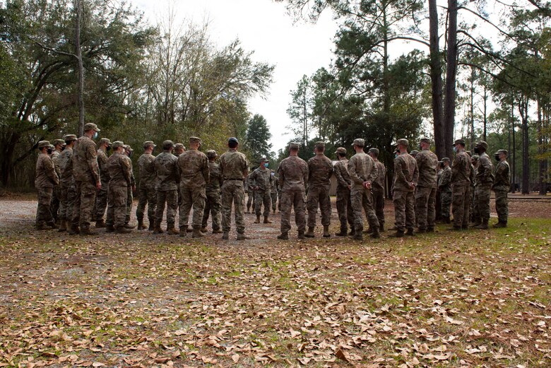 A photo of General Harrigian talking to Airmen during a visit.