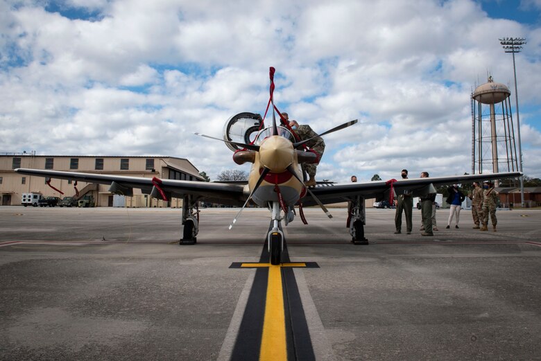 A photo of General Harrigian looking inside of an A-29 Super Tucano.
