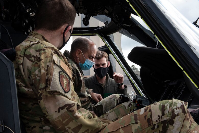 A picture of General Harrigian sitting in an HH-60W Jolly Green II.