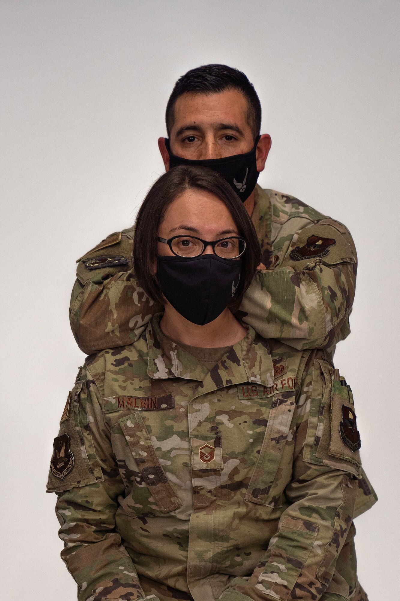 Master Sgt. Marissa Malmin, Second Air Force personnel programs superintendent, and Master Sgt. Jason Martinez, 81st Healthcare Operations Squadron first sergeant, pose for a photo in Wall Studio at Keesler Air Force Base, Mississippi, Feb. 10, 2021. Malmin and Martinez have been married for 20 years. (U.S. Air Force photo by Airman 1st Class Jasmine Galloway)