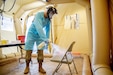 Army Pfc. Christopher Elsberry, assigned to the 36th Medical Company Area Support Battalion, sanitizes a chair inside the mobile COVID-19 testing unit at the Javits Center in New York City, May 19, 2020.