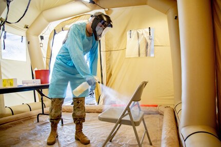Army Pfc. Christopher Elsberry, assigned to the 36th Medical Company Area Support Battalion, sanitizes a chair inside the mobile COVID-19 testing unit at the Javits Center in New York City, May 19, 2020.