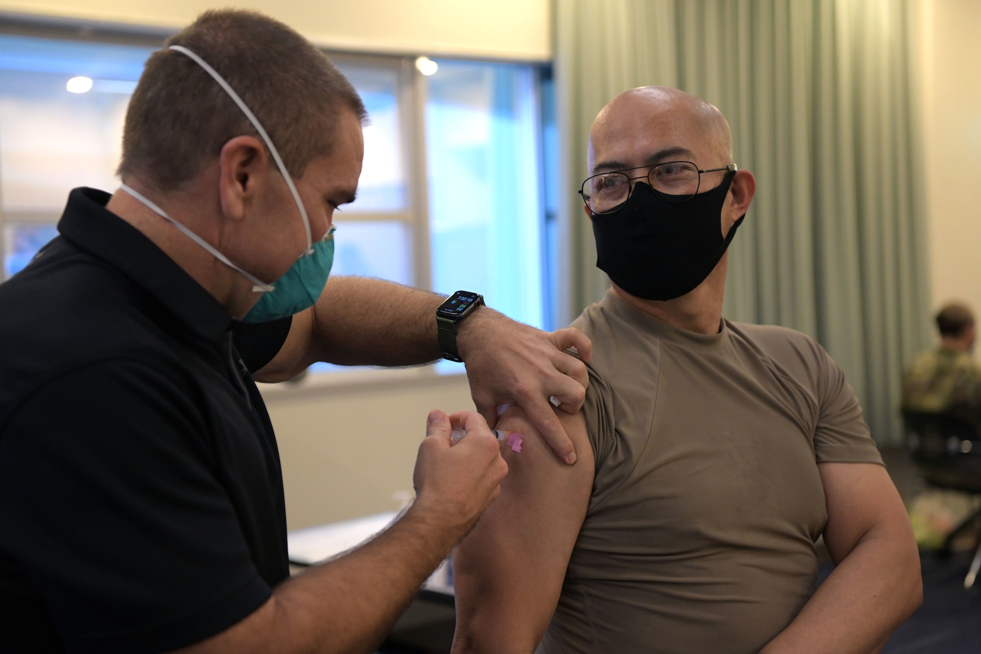Red Cross volunteers and paramedics administer the Moderna COVID-19 vaccine to Team Kadena’s first-line defenders, Jan. 29, 2021, at Kadena Air Base, Japan. The COVID-19 vaccination plan is phase-driven and designed to safely protect members within the DoD as quickly as possible. (U.S. Air Force photo by Airman 1st Class Rebeckah Medeiros)