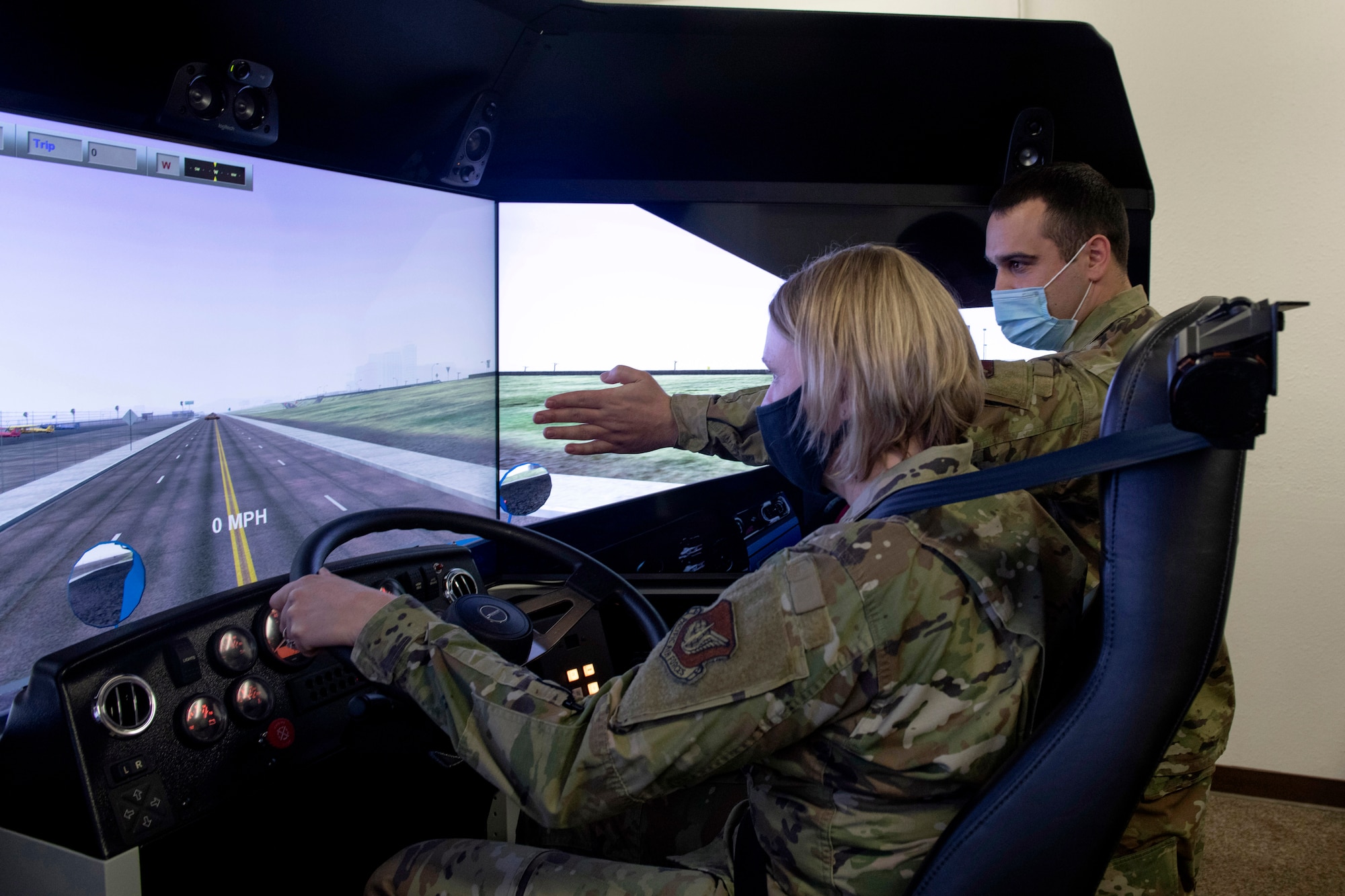 U.S. Air Force Staff Sgt. Tyler Vines, right, a unit deployment manager assigned to the 773d Logistics Readiness Squadron, teaches U.S. Air Force Col. Kirsten Aguilar, left, Joint Base Elmendorf-Richardson and 673d Air Base Wing commander, how operate a driving simulator during a 773d LRS immersion tour at JBER, Alaska, Jan. 29, 2021. Aguilar familiarized herself with the squadron and its role in supporting the installation’s mission readiness after taking command of the installation July 14, 2020. The 773d LRS provides cargo movement, vehicle operations and aerial port functions to both Airmen and Soldiers across the installation.