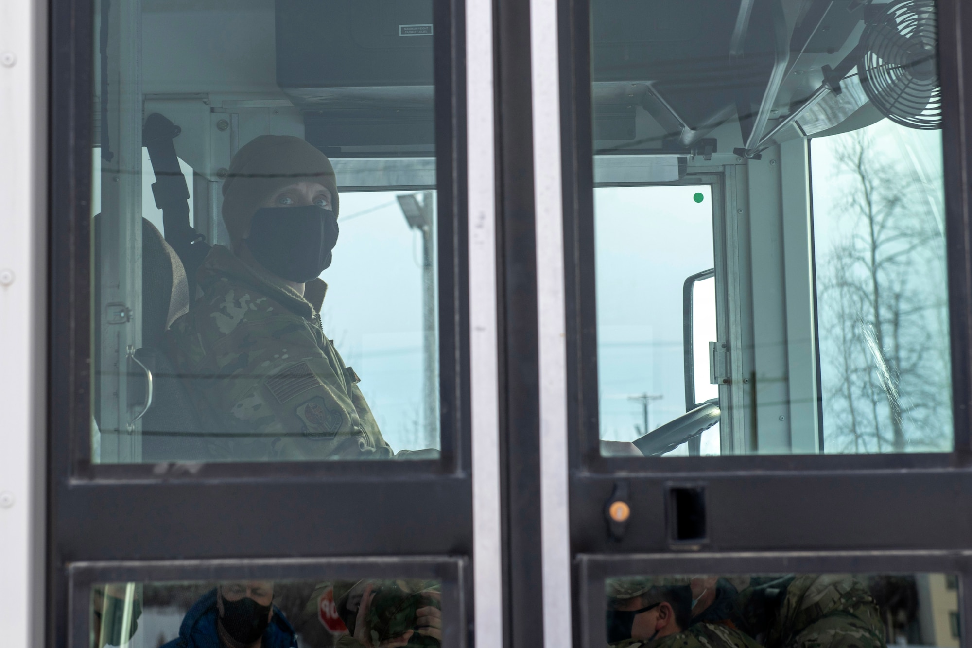U.S. Air Force Chief Master Sgt. Lee Mills, Joint Base Elmendorf-Richardson and 673d Air Base Wing command chief, learns how to operate a bus during a 773d Logistics Readiness Squadron immersion tour at JBER, Alaska, Jan. 29, 2021. U.S. Air Force Col. Kirsten Aguilar, JBER and 673d Air Base Wing commander, toured the squadron to familiarize herself with the 773d LRS and its role in supporting the installation’s mission readiness after taking command of the installation July 14, 2020. The 773d LRS provides cargo movement, vehicle operations and aerial port functions to both Airmen and Soldiers across the installation.