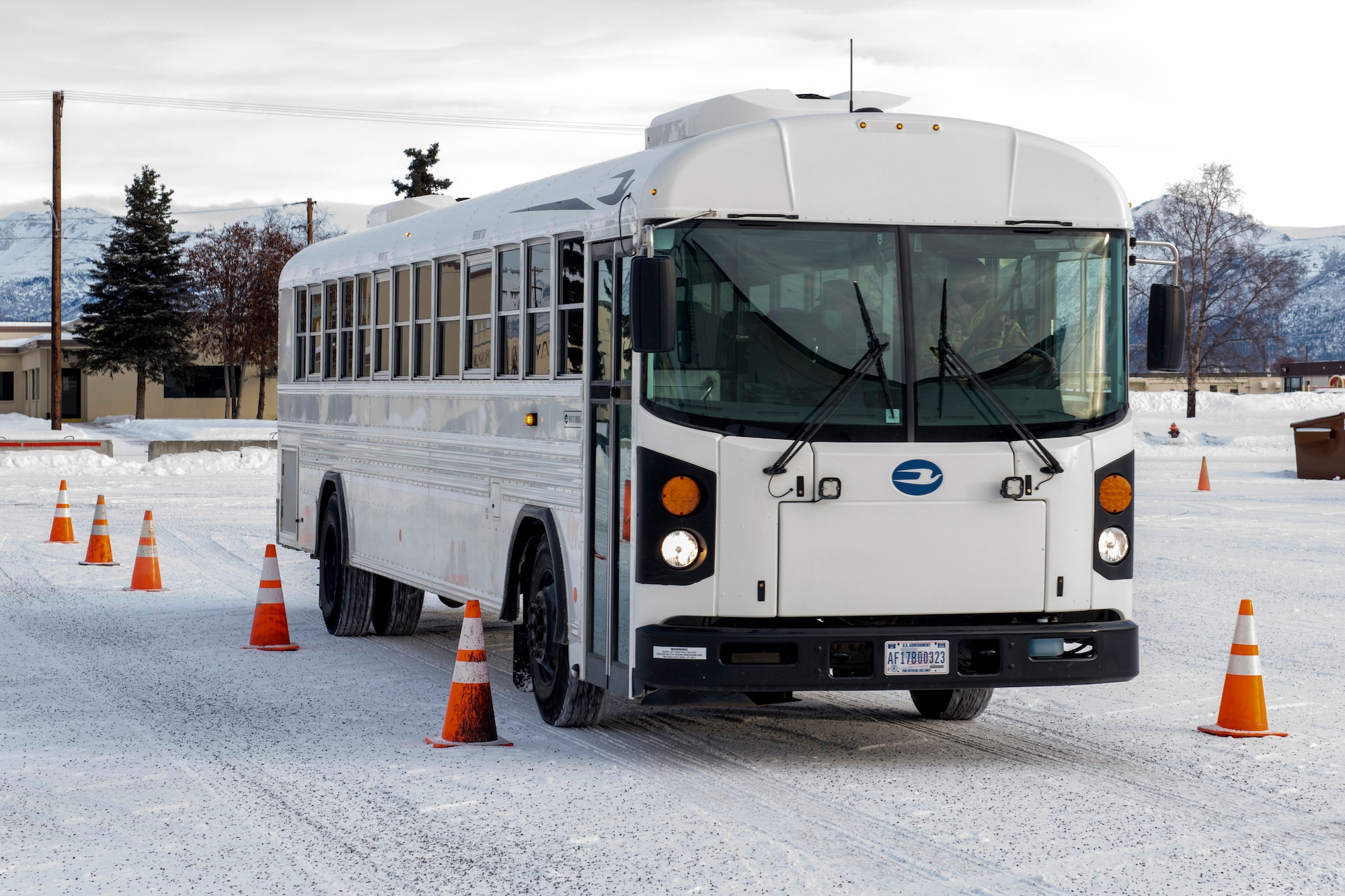 U.S. Air Force Chief Master Sgt. Lee Mills, Joint Base Elmendorf-Richardson and 673d Air Base Wing command chief, learns how to operate a bus during a 773d Logistics Readiness Squadron immersion tour at JBER, Alaska, Jan. 29, 2021. U.S. Air Force Col. Kirsten Aguilar, JBER and 673d Air Base Wing commander, toured the squadron to familiarize herself with the 773d LRS and its role in supporting the installation’s mission readiness after taking command of the installation July 14, 2020. The 773d LRS provides cargo movement, vehicle operations and aerial port functions to both Airmen and Soldiers across the installation.