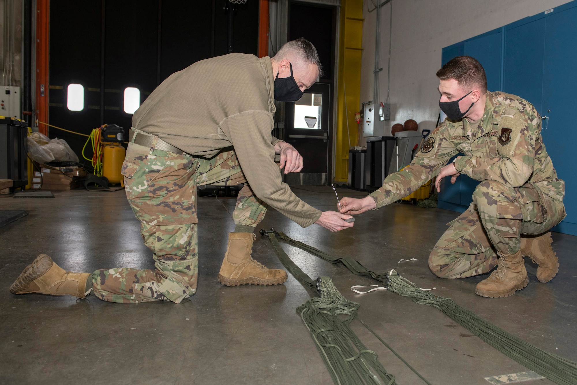 U.S. Air Force Staff Sgt. David Throckmorton, a combat mobility technician assigned to the 773d Logistics Readiness Squadron, teaches U.S. Air Force Chief Master Sgt. Lee Mills, Joint Base Elmendorf-Richardson and 673d Air Base Wing command chief, how to pack a parachute during a 773d LRS immersion tour at JBER, Alaska, Jan. 29, 2021. U.S. Air Force Col. Kirsten Aguilar, Joint Base Elmendorf-Richardson and 673d Air Base Wing commander, toured the squadron to familiarize herself with the 773d LRS and its role in supporting the installation’s mission readiness after taking command of the installation July 14, 2020. The 773d LRS provides cargo movement, vehicle operations and aerial port functions to both Airmen and Soldiers across the installation.