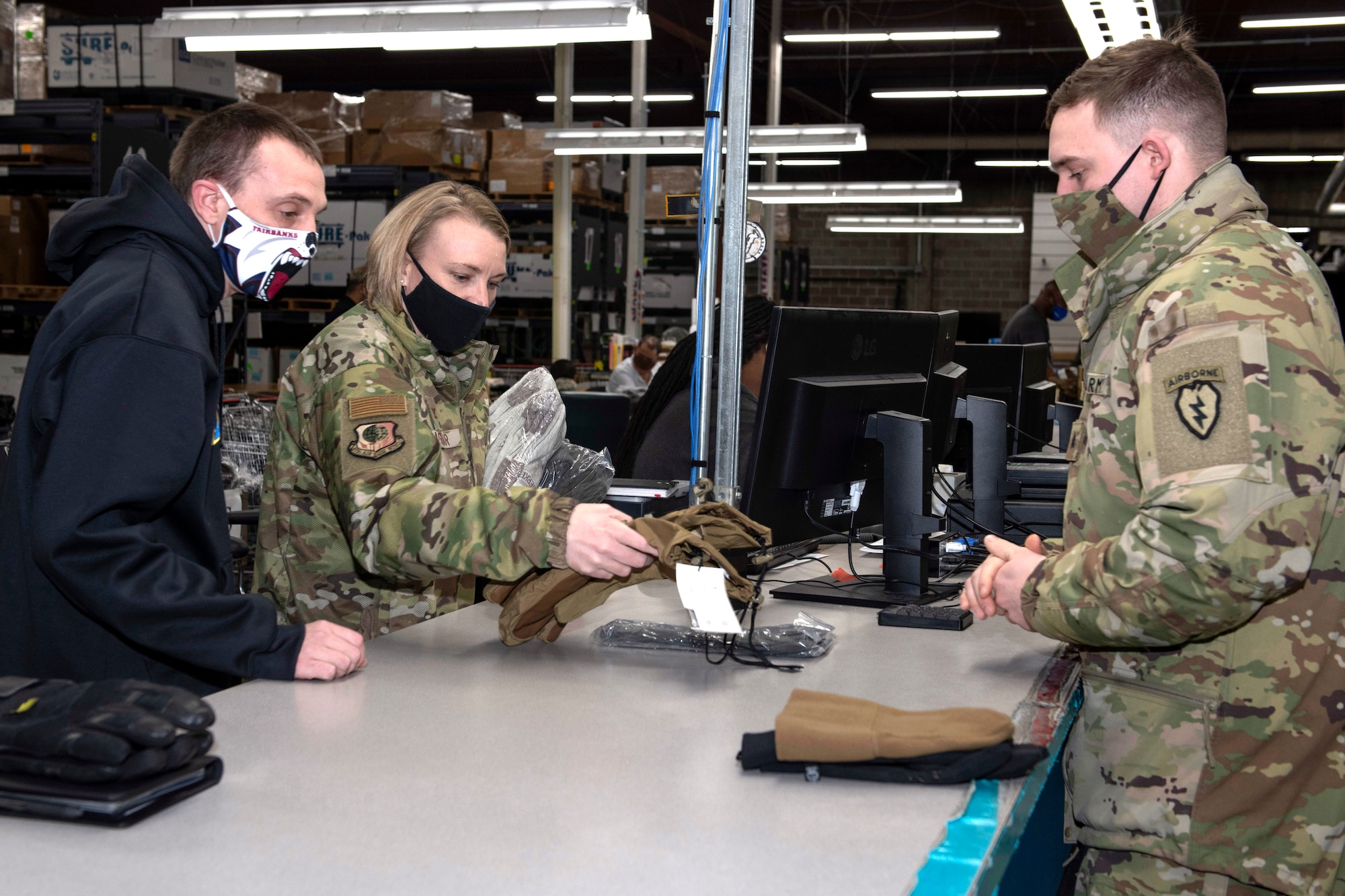 U.S. Air Force Col. Kirsten Aguilar, Joint Base Elmendorf-Richardson and 673d Air Base Wing commander, helps personnel assigned to the 773d Logistics Readiness Squadron issue equipment to Soldiers assigned to U.S. Army Alaska during a 773d LRS immersion tour at JBER, Alaska, Jan. 29, 2021. Aguilar familiarized herself with the squadron and its role in supporting the installation’s mission readiness after taking command of the installation July 14, 2020. The 773d LRS provides cargo movement, vehicle operations and aerial port functions to both Airmen and Soldiers across the installation.