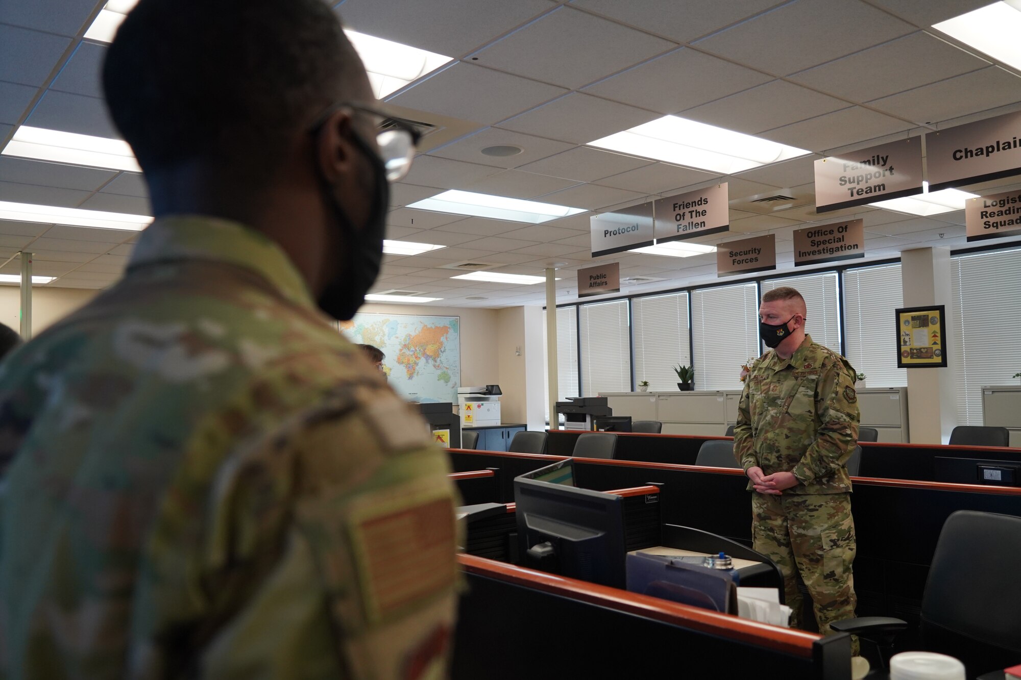 Chief Master Sgt. Chad Bickley, 18th Air Force command chief, receives a briefing from the Command, Control, and Communications team at Air Force Mortuary Affairs Operations, Dover Air Force Base, Delaware, Feb. 11, 2021. The C3 center is manned 24 hours a day in critical support of the AFMAO mission. (U.S. Air Force photo by Staff Sgt. Benjamin N. Valmoja)