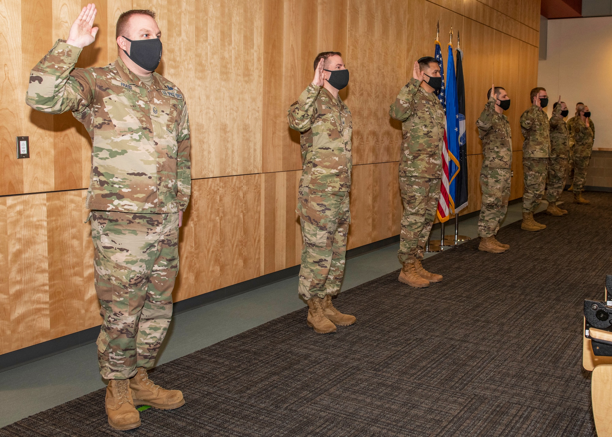 U.S. Airmen take the Oath of Enlistment into the U.S. Space Force during a ceremony at Joint Base Elmendorf-Richardson, Alaska, Feb. 11, 2021. During the ceremony, JBER had seven Airmen earn their new title of Guardian by officially swearing into the newest branch of the armed forces.