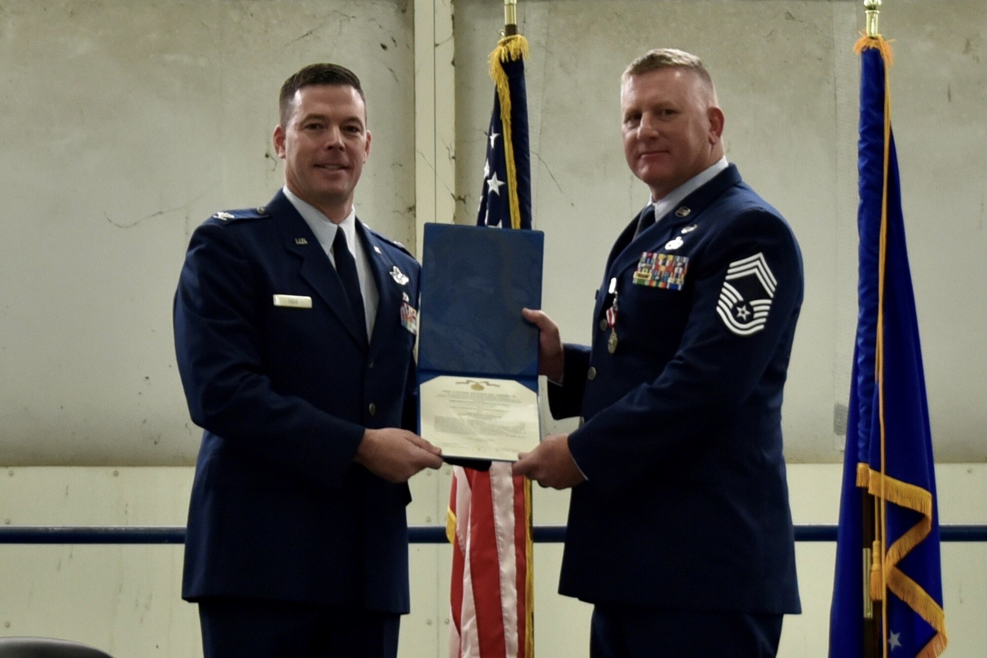 (right) Chief Master Sgt. Tommy Chasteen, 73d Aerial Port Squadron chief enlisted manager, completed his military 32 years of service at his retirement ceremony at U.S. Naval Air Station Joint Reserve Base Fort Worth, Texas  on February 6, 2021. Col. Gavin Tade, 10th Air Force Standardization and Evaluation Division chief, presided over the ceremony. (U.S. Air Force photo by Staff Sgt. Randall Moose)
