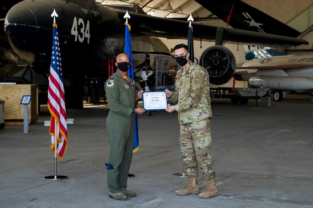 1st Lt. Cody Bronkar, 412th Communications Squadron, accepts his U.S. Space Force certificate from Col. Randel Gordon, 412th Test Wing Vice Commander, during a Space Force Transfer Ceremony at Edwards Air Force Base, California, Feb. 11. (Air Force photo by Richard Gonzales)