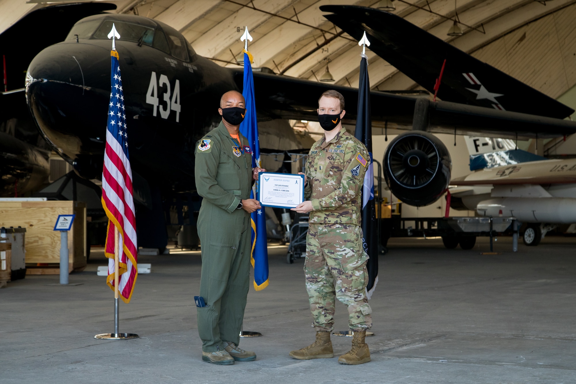 1st Lt. Craig Carlson, 412th Operations Group, originally of Boulder, Colorado, accepts his U.S. Space Force certificate from Col. Randel Gordon, 412th Test Wing Vice Commander during a Space Force Transfer Ceremony at Edwards Air Force Base, California, Feb. 11. (Air Force photo by Richard Gonzales)