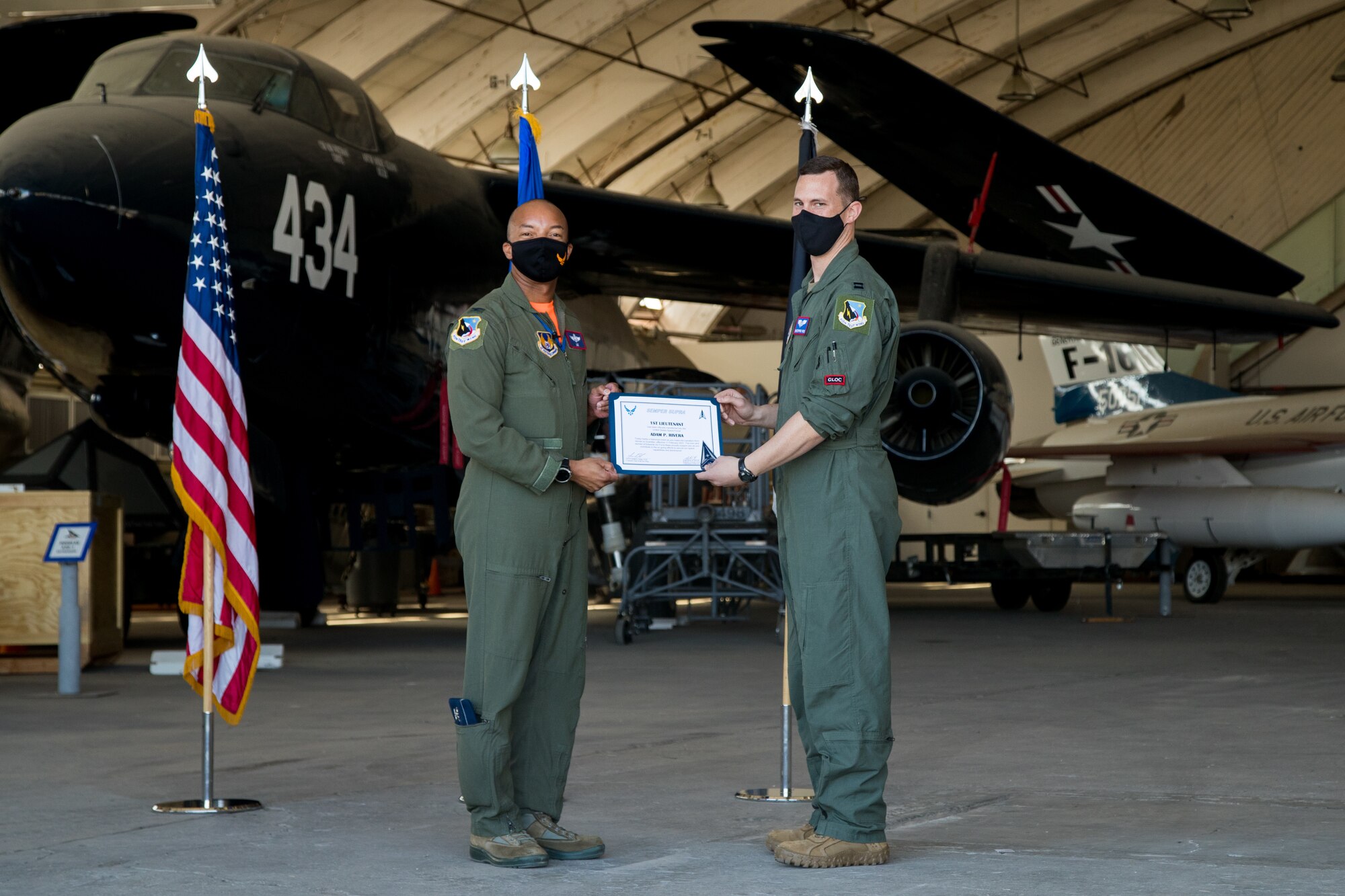 Capt. Christopher Reis, accepts his U.S. Space Force certificate from Col. Randel Gordon, 412th Test Wing Vice Commander, during a Space Force Transfer Ceremony at Edwards Air Force Base, California, Feb. 11. (Air Force photo by Richard Gonzales)