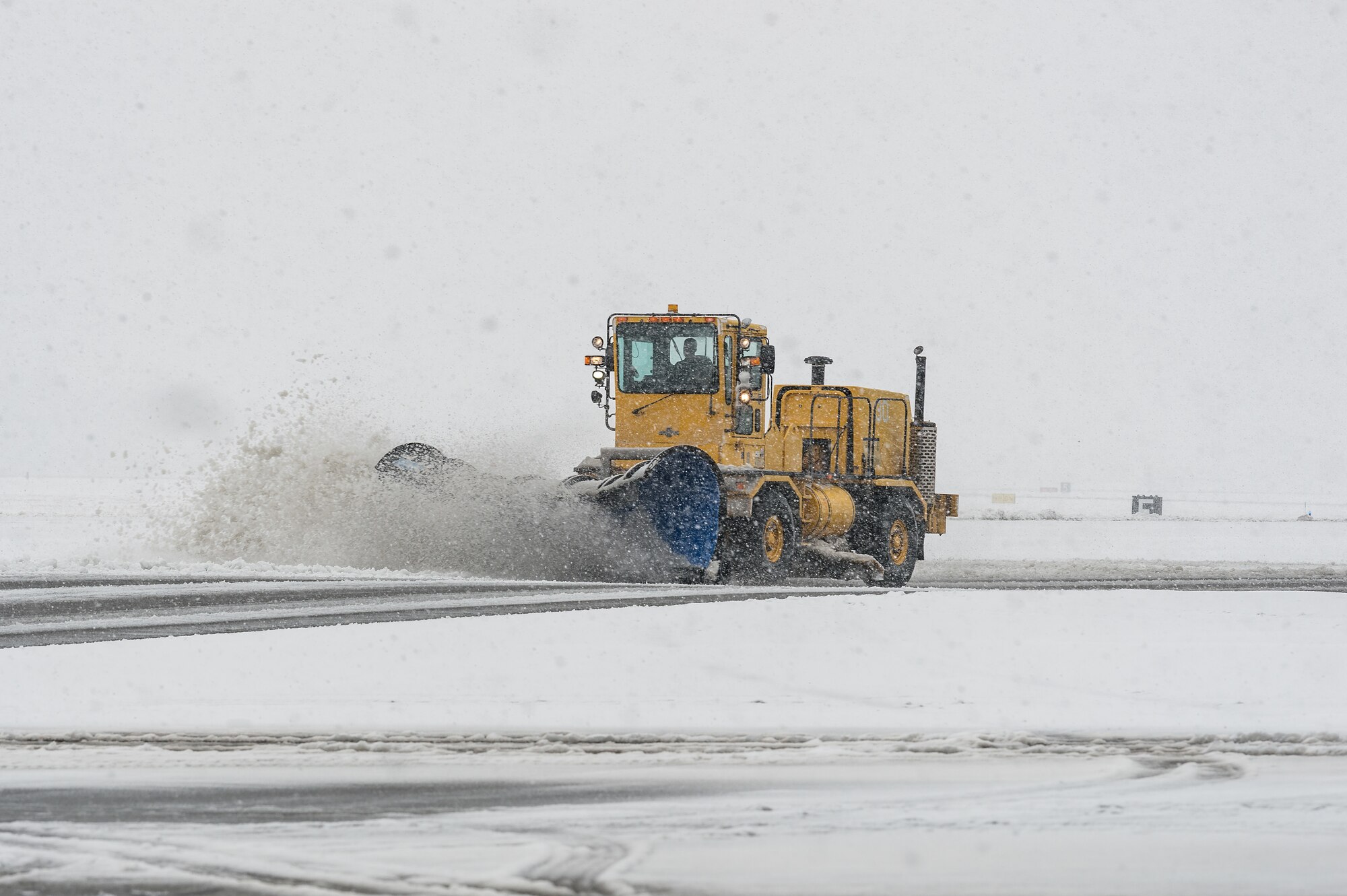 A 436th Civil Engineer Squadron snowplow clears snow from the flight line at Dover Air Force Base, Delaware, Feb. 11, 2021. As Winter Storm Roland produced a wintry mix of precipitation, the base continued normal operations and prepared for additional forecast snowfall. (U.S. Air Force photo by Roland Balik)