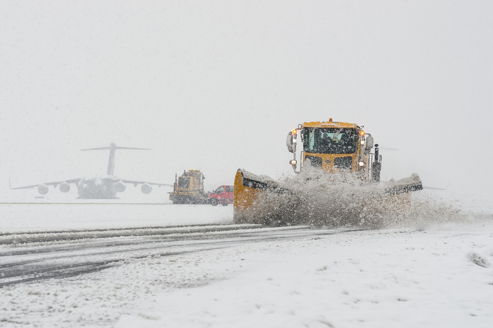 A 436th Civil Engineer Squadron snowplow clears snow from the flight line at Dover Air Force Base, Delaware, Feb. 11, 2021. As Winter Storm Roland produced a wintry mix of precipitation, the base continued normal operations and prepared for additional forecast snowfall. (U.S. Air Force photo by Roland Balik)