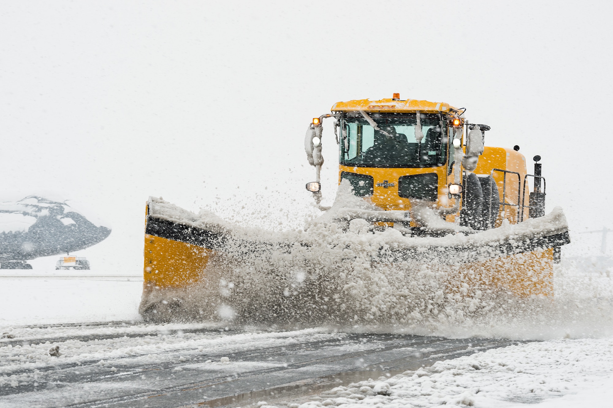 A 436th Civil Engineer Squadron snowplow clears snow from the flight line at Dover Air Force Base, Delaware, Feb. 11, 2021. As Winter Storm Roland produced a wintry mix of precipitation, the base continued normal operations and prepared for additional forecast snowfall. (U.S. Air Force photo by Roland Balik)