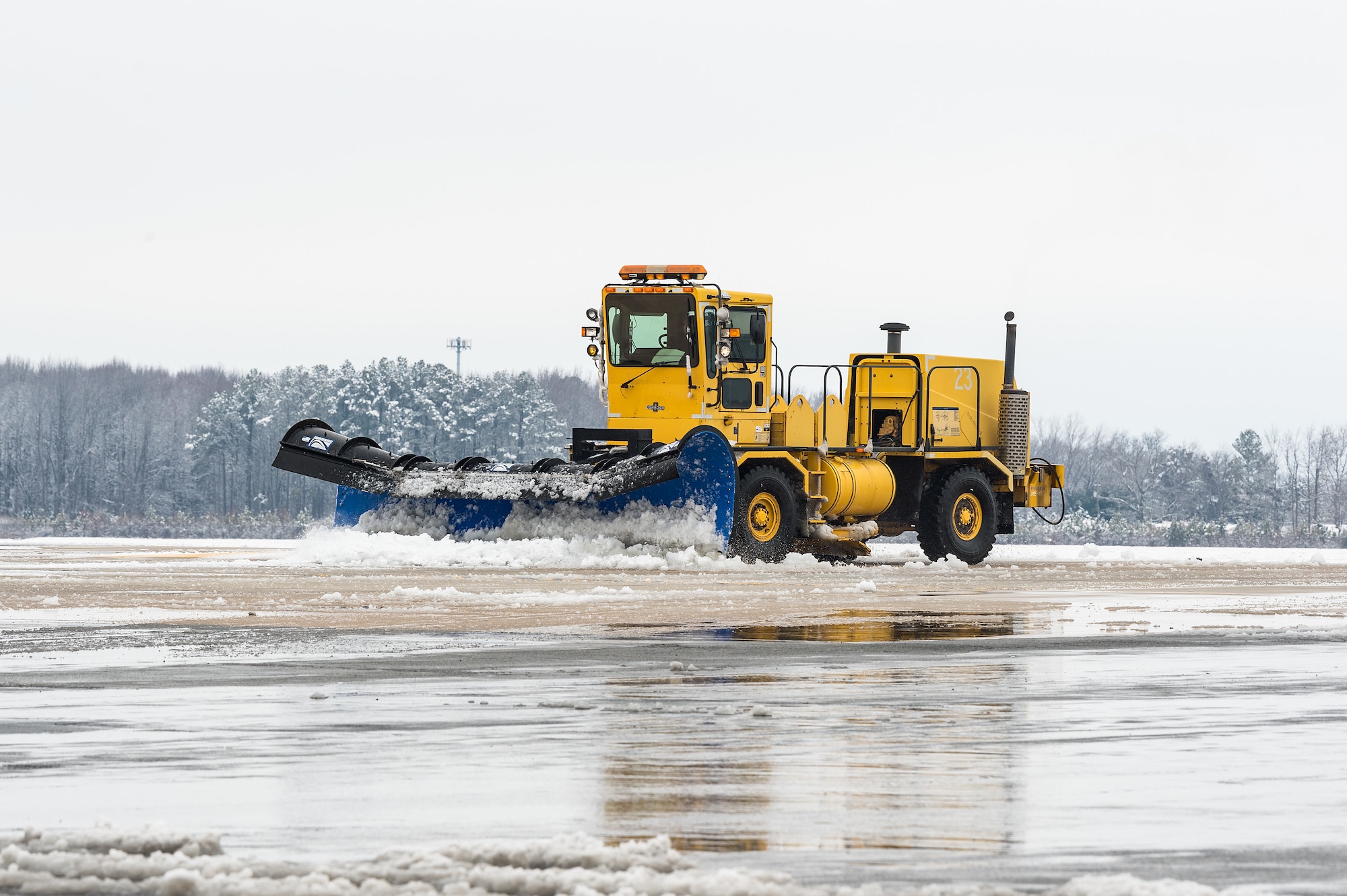 A 436th Civil Engineer Squadron snowplow clears snow from the flight line at Dover Air Force Base, Delaware, Feb. 11, 2021. As Winter Storm Roland produced a wintry mix of precipitation, the base continued normal operations and prepared for additional forecast snowfall. (U.S. Air Force photo by Roland Balik)