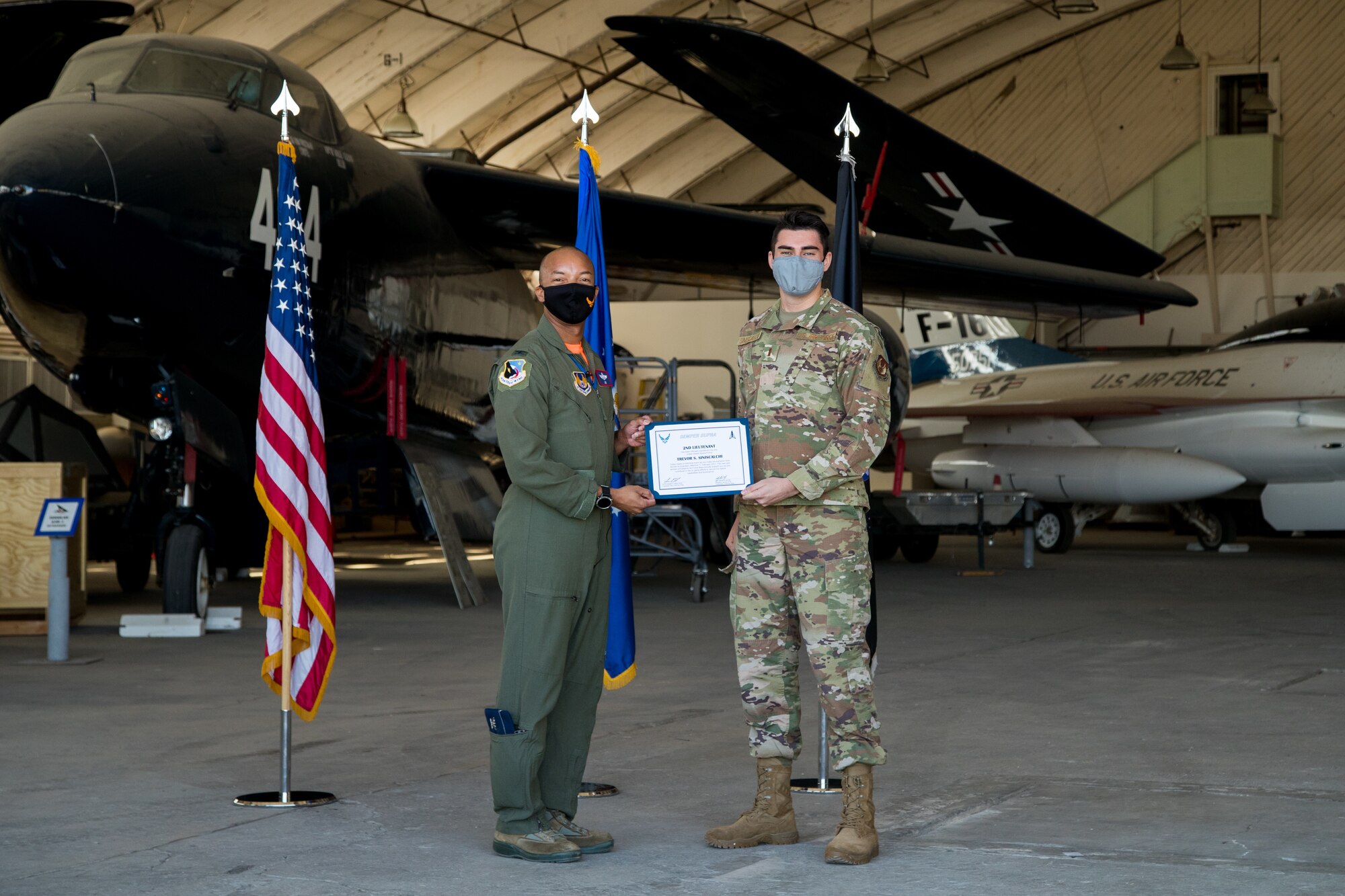 2nd Lt. Trevor Siniscalchi, Air Force Research Laboratory, originally of San Diego, California, accepts his U.S. Space Force certificate from Col. Randel Gordon, 412th Test Wing Vice Commander, during a Space Force Transfer Ceremony at Edwards Air Force Base, California, Feb. 11. (Air Force photo by Richard Gonzales)