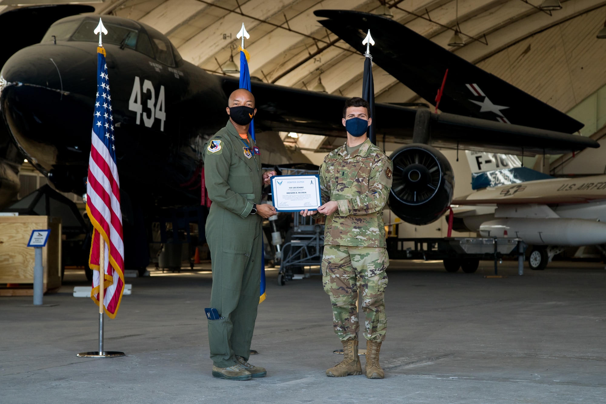 1st Lt. Brendan Ruchlin, 418th Flight Test Squadron, accepts his U.S. Space Force certificate from Col. Randel Gordon, 412th Test Wing Vice Commander, during a Space Force Transfer Ceremony at Edwards Air Force Base, California, Feb. 11. (Air Force photo by Richard Gonzales)