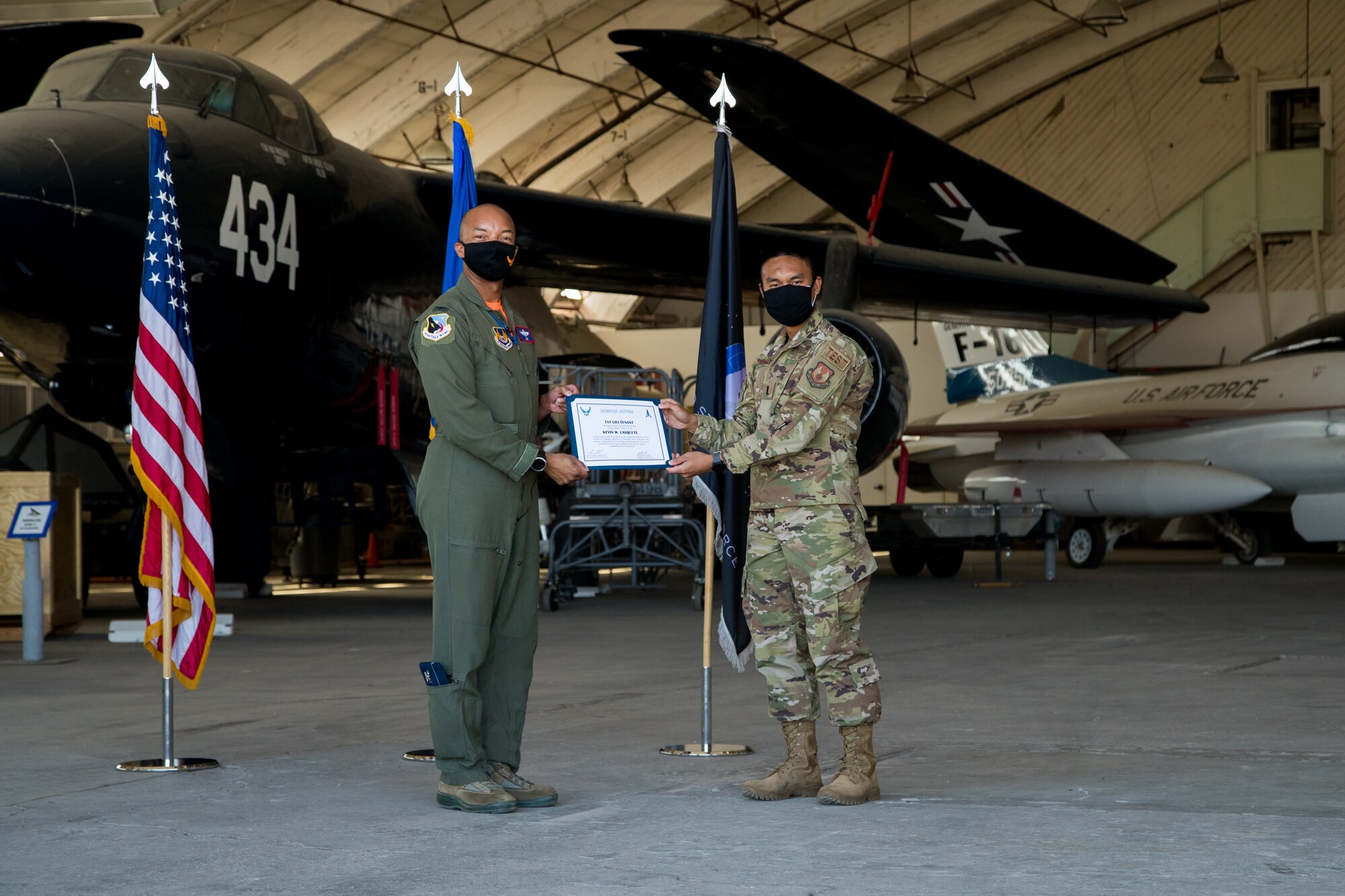 1st Lt. Kevin Lasquette, 772nd Test Squadron, originally from San Diego, California, accepts his U.S. Space Force certificate from Col. Randel Gordon, 412th Test Wing Vice Commander, during a Space Force Transfer Ceremony at Edwards Air Force Base, California, Feb. 11. (Air Force photo by Richard Gonzales)