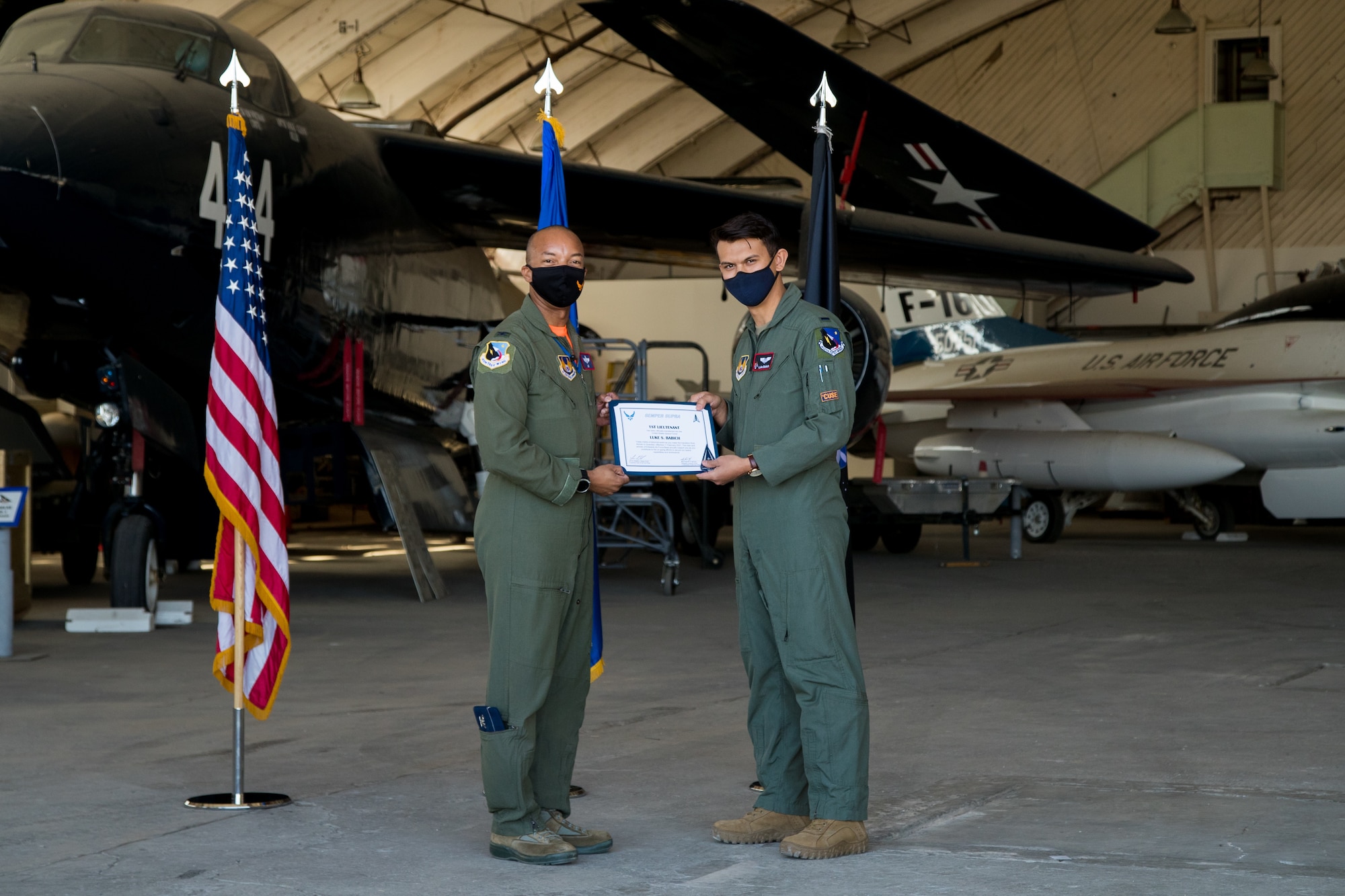 1st Lt. Luke Babich, 418th Flight Test Squadron, originally of Dix Hills, New York, accepts his U.S. Space Force certificate from Col. Randel Gordon, 412th Test Wing Vice Commander, during a Space Force Transfer Ceremony at Edwards Air Force Base, California, Feb. 11. (Air Force photo by Richard Gonzales)