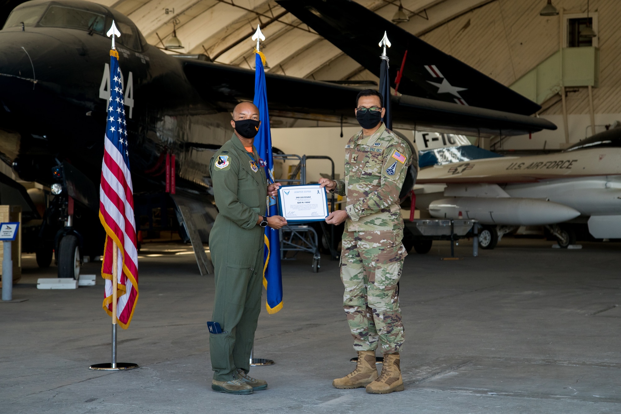 2nd Lt. Qazi Faraz, 773rd Test Squadron, originally of Houston, Texas, accepts his U.S. Space Force certificate from Col. Randel Gordon, 412th Test Wing Vice Commander, during a Space Force Transfer Ceremony at Edwards Air Force Base, California, Feb. 11. (Air Force photo by Richard Gonzales)