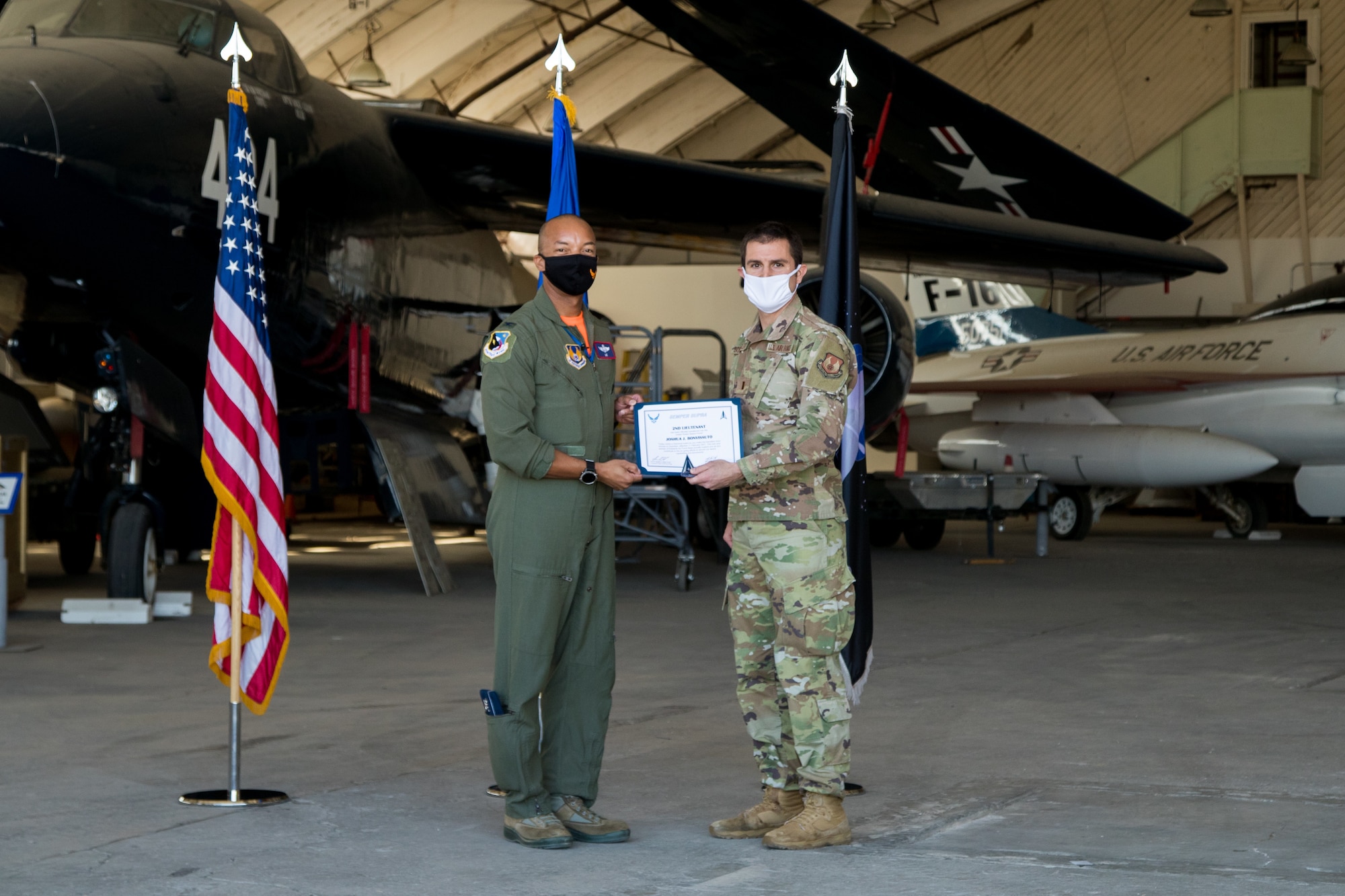 2nd Lt. Joshua Bonvisutto, Air Force Research Laboratory, originally of North Tonawanda, Ney York, accepts his U.S. Space Force certificate from Col. Randel Gordon, 412th Test Wing Vice Commander, during a Space Force Transfer Ceremony at Edwards Air Force Base, California, Feb. 11. (Air Force photo by Richard Gonzales)