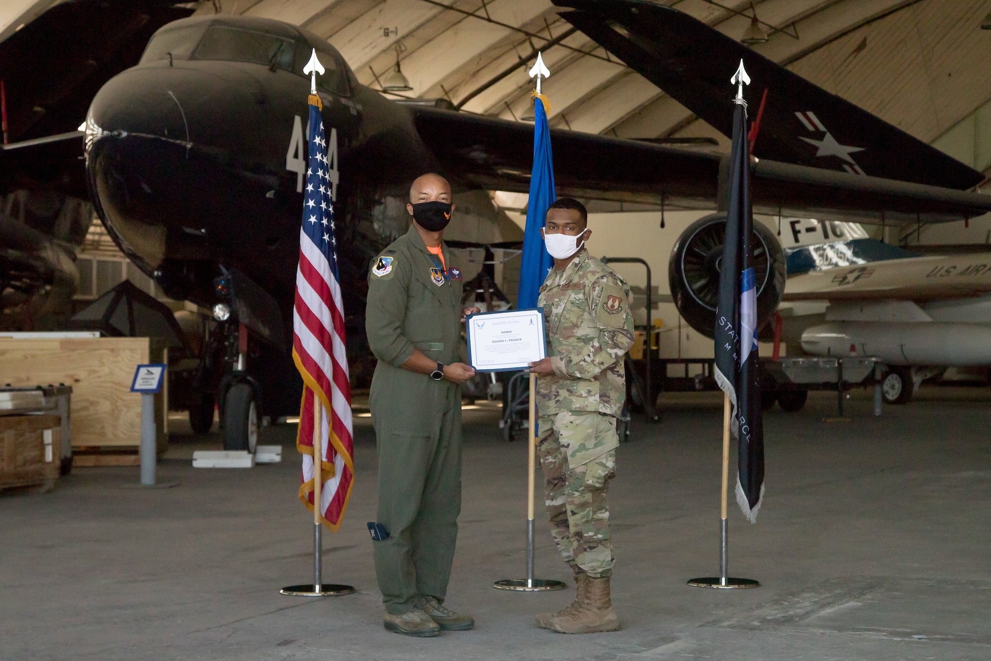 Airman Rashon Pradier, 412th Communications Squadron, originally of Lewisville, Texas, accepts his U.S. Space Force certificate from Col. Randel Gordon, 412th Test Wing Vice Commander, during a Space Force Transfer Ceremony at Edwards Air Force Base, California, Feb. 11. (Air Force photo by Richard Gonzales)