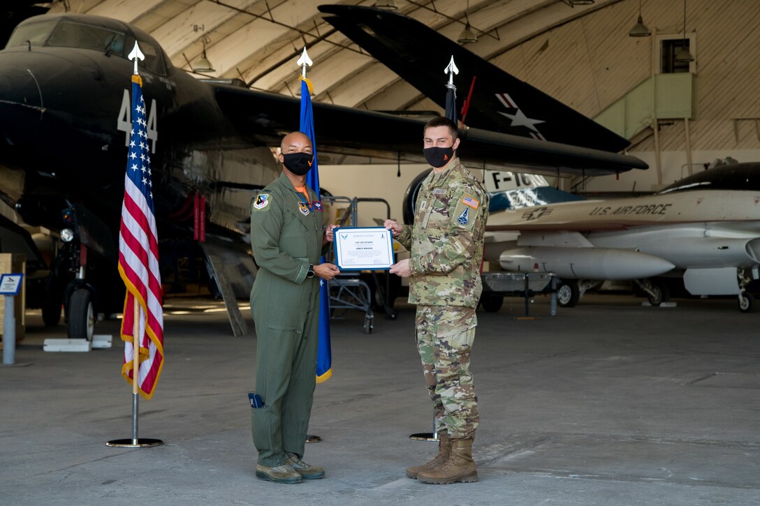 1st Lt. Jared Bogdan accepts his U.S. Space Force certificate from Col. Randel Gordon, 412th Test Wing Vice Commander, during a Space Force Transfer Ceremony at Edwards Air Force Base, California, Feb. 11. (Air Force photo by Richard Gonzales)