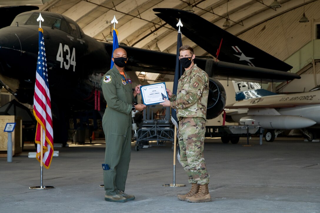 Capt. Karson Roberts, Air Force Research Laboratory, originally of Houston, Texas, accepts his U.S. Space Force certificate from Col. Randel Gordon, 412th Test Wing Vice Commander, during a Space Force Transfer Ceremony at Edwards Air Force Base, California, Feb. 11. (Air Force photo by Richard Gonzales)