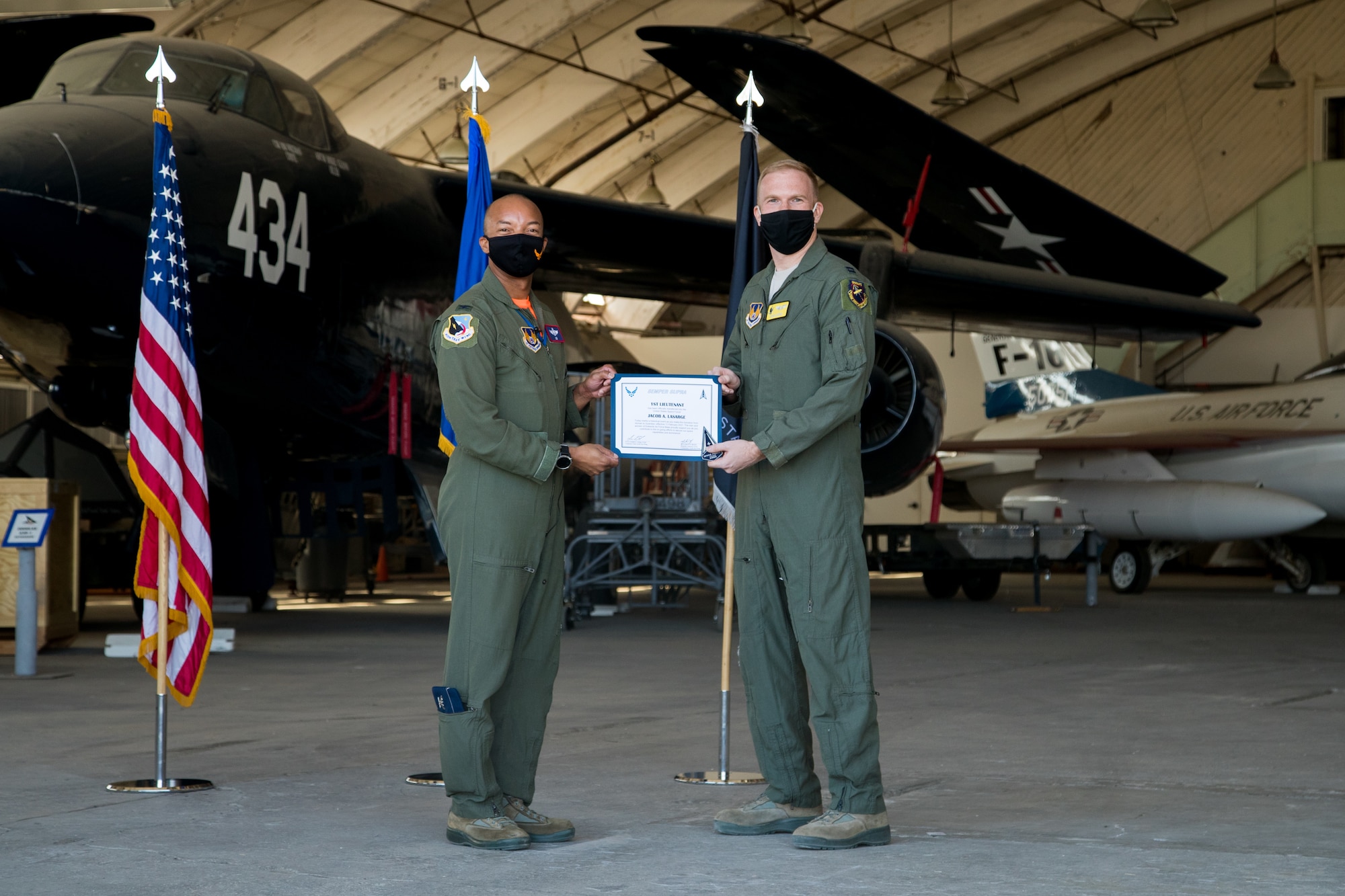 Capt. Jacob LaSarge, 452nd Flight Test Squadron, originally of Byron Center, Michigan, accepts his U.S. Space Force certificate from Col. Randel Gordon, 412th Test Wing Vice Commander during a Space Force Transfer Ceremony at Edwards Air Force Base, California, Feb. 11. (Air Force photo by Richard Gonzales)