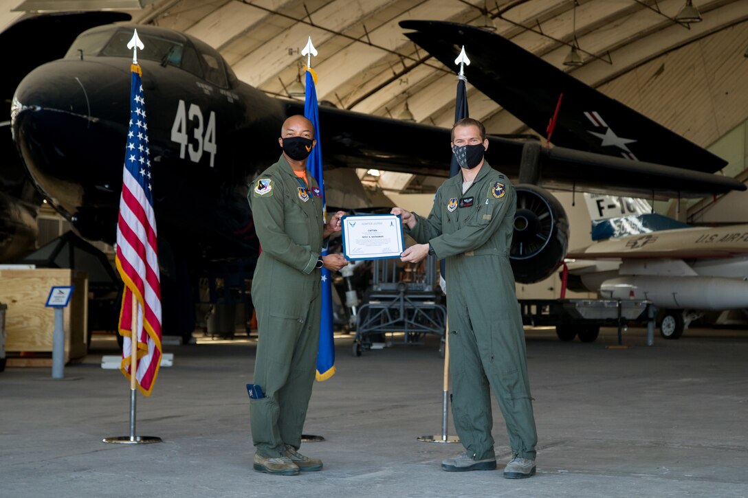 Capt. Kyle Hathaway, 461st Flight Test Squadron, originally of Portland, Oregon, accepts his U.S. Space Force certificate from Col. Randel Gordon, 412th Test Wing Vice Commander, during a Space Force Transfer Ceremony at Edwards Air Force Base, California, Feb. 11. (Air Force photo by Richard Gonzales)