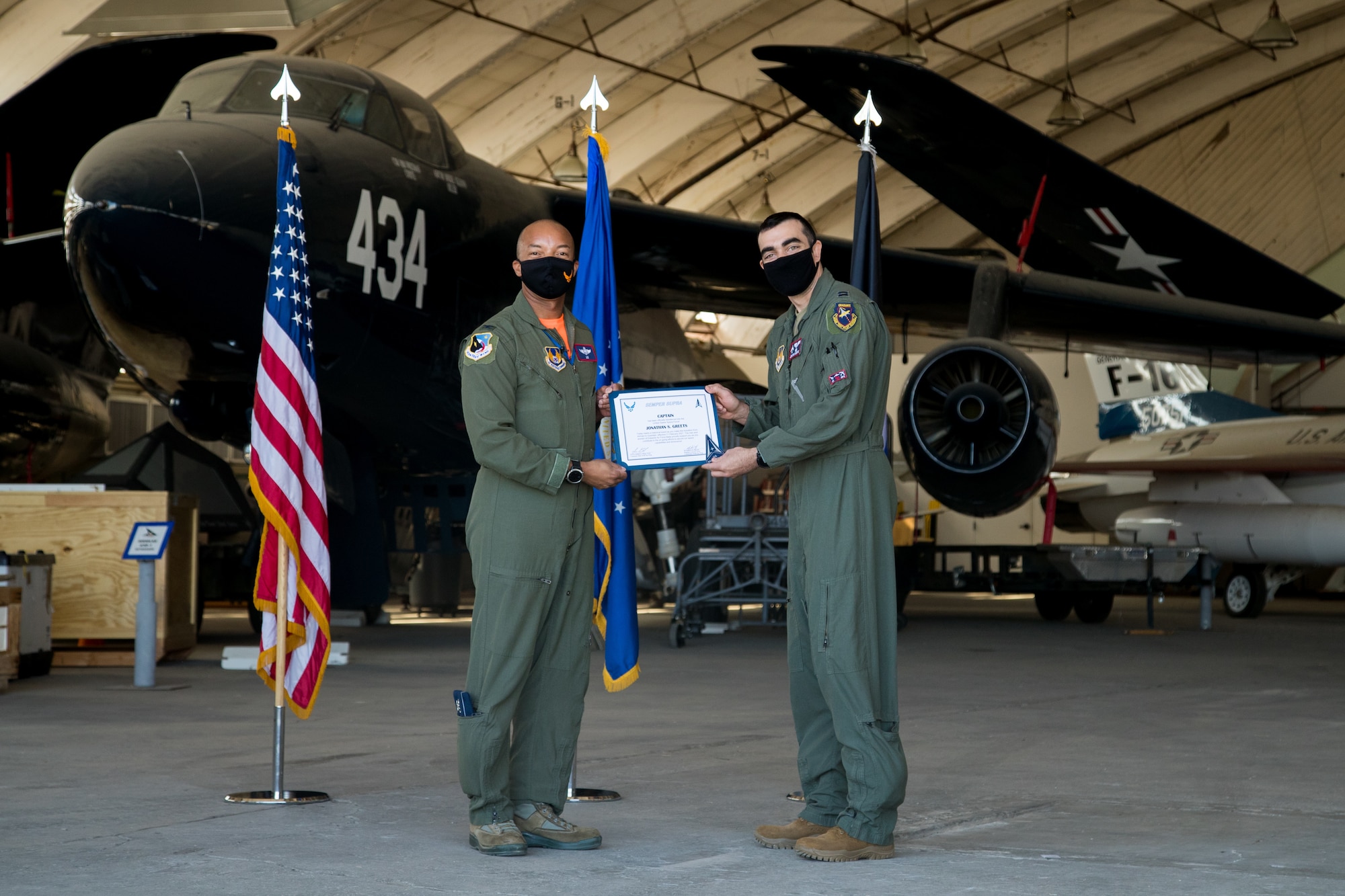 Capt. Jonathan Geerts, 419th Flight Test Squadron, originally of Berwyn, Pennsylvania, accepts his U.S. Space Force certificate from Col. Randel Gordon, 412th Test Wing Vice Commander during a Space Force Transfer Ceremony at Edwards Air Force Base, California, Feb. 11. (Air Force photo by Richard Gonzales)