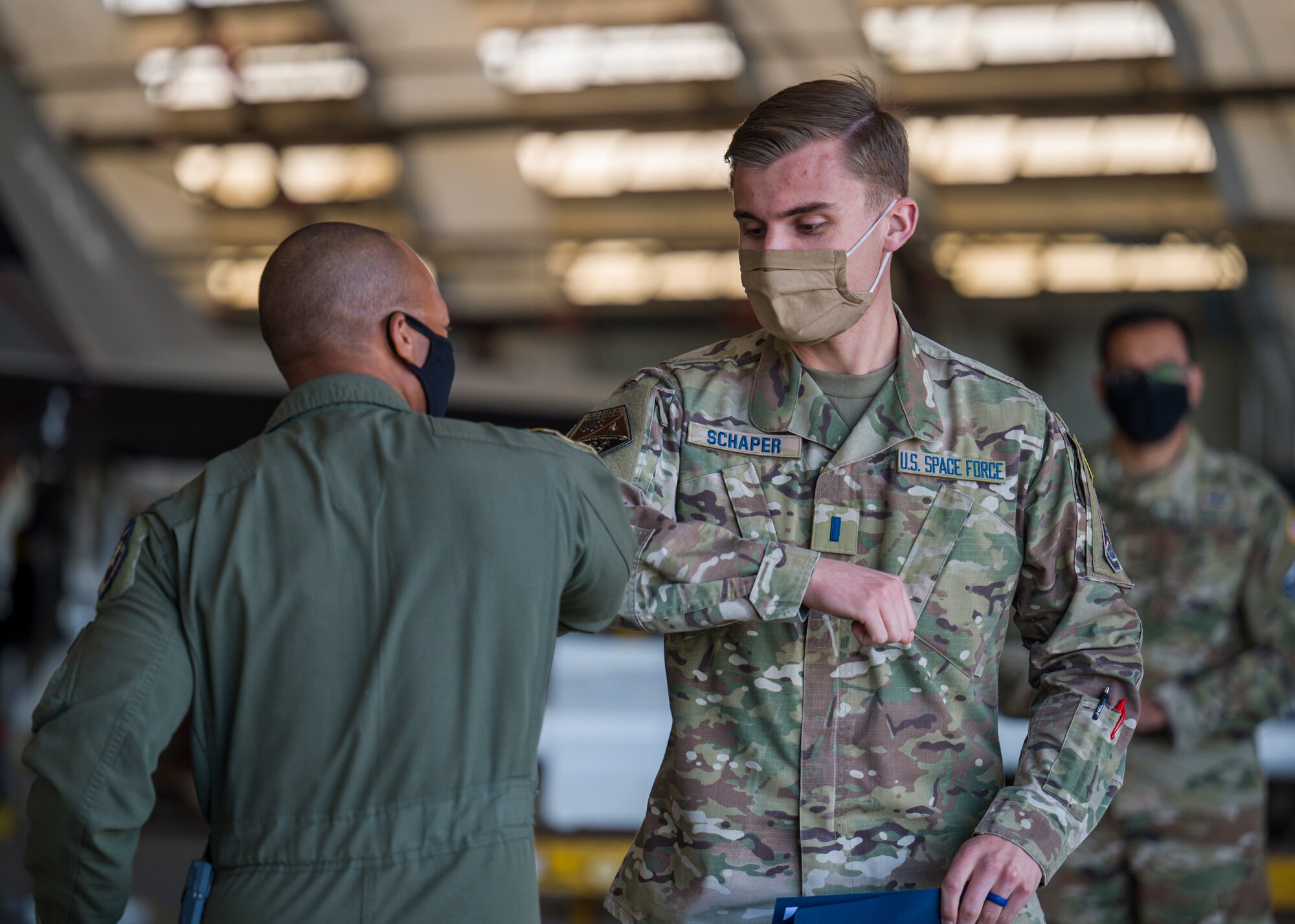 1st Lt. Lucas Schaper, Space Test Fundamentals Class 21-1, U.S. Air Force Test Pilot School, is congratulated by Col. Randel Gordon, 412th Test Wing Vice Commander, during a Space Force Transfer Ceremony at Edwards Air Force Base, California, Feb. 11. (Air Force photo by Giancarlo Casem)