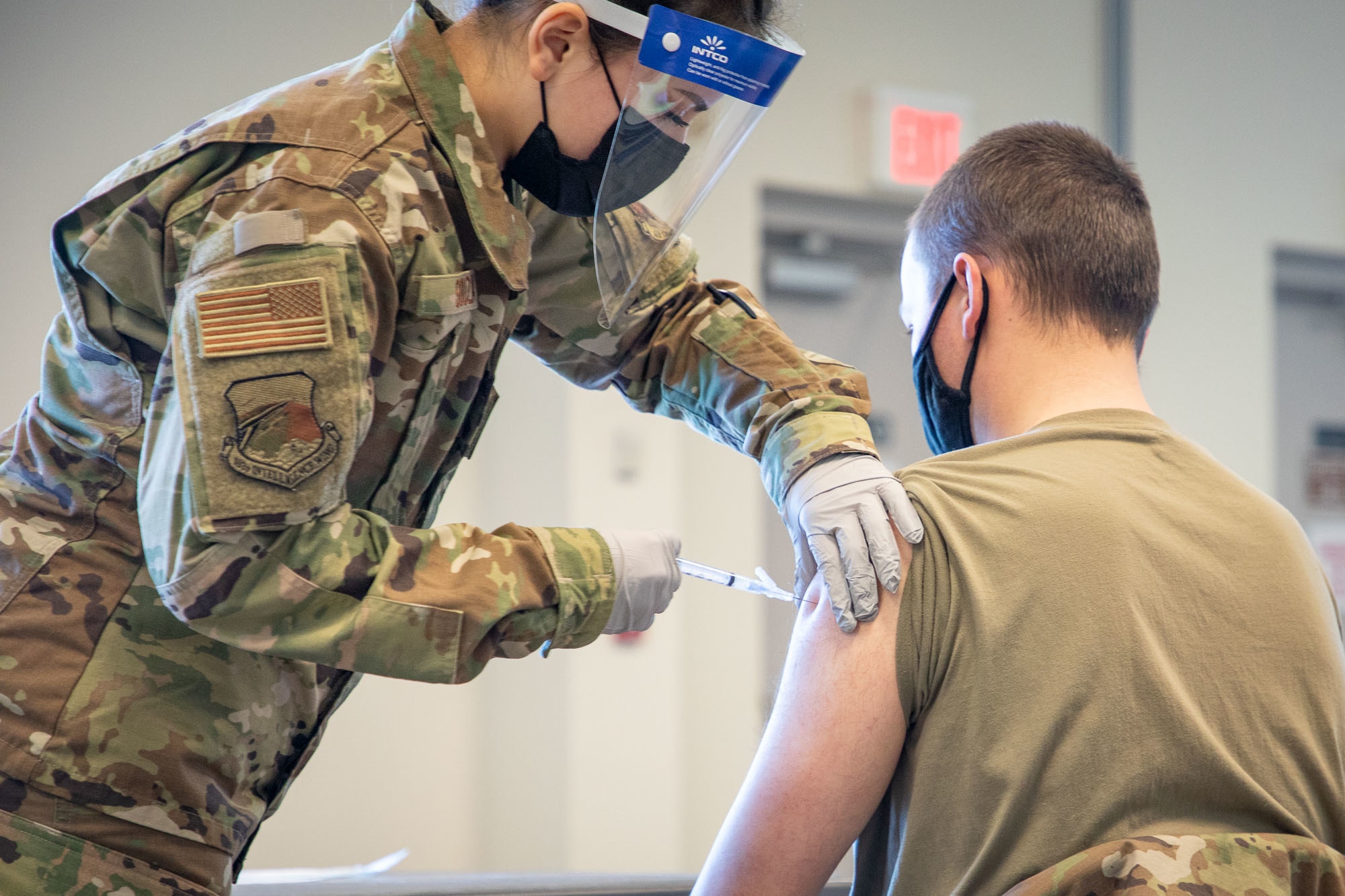 Staff Sgt. Bruna Souza, 102nd Medical Group, administers a COVID-19 vaccine during an immunization clinic at Otis Air National Guard Base, Feb. 6, 2021. The vaccine will be delivered in a phased approach, beginning with emergency services personnel, security forces, and medical and health care professionals.