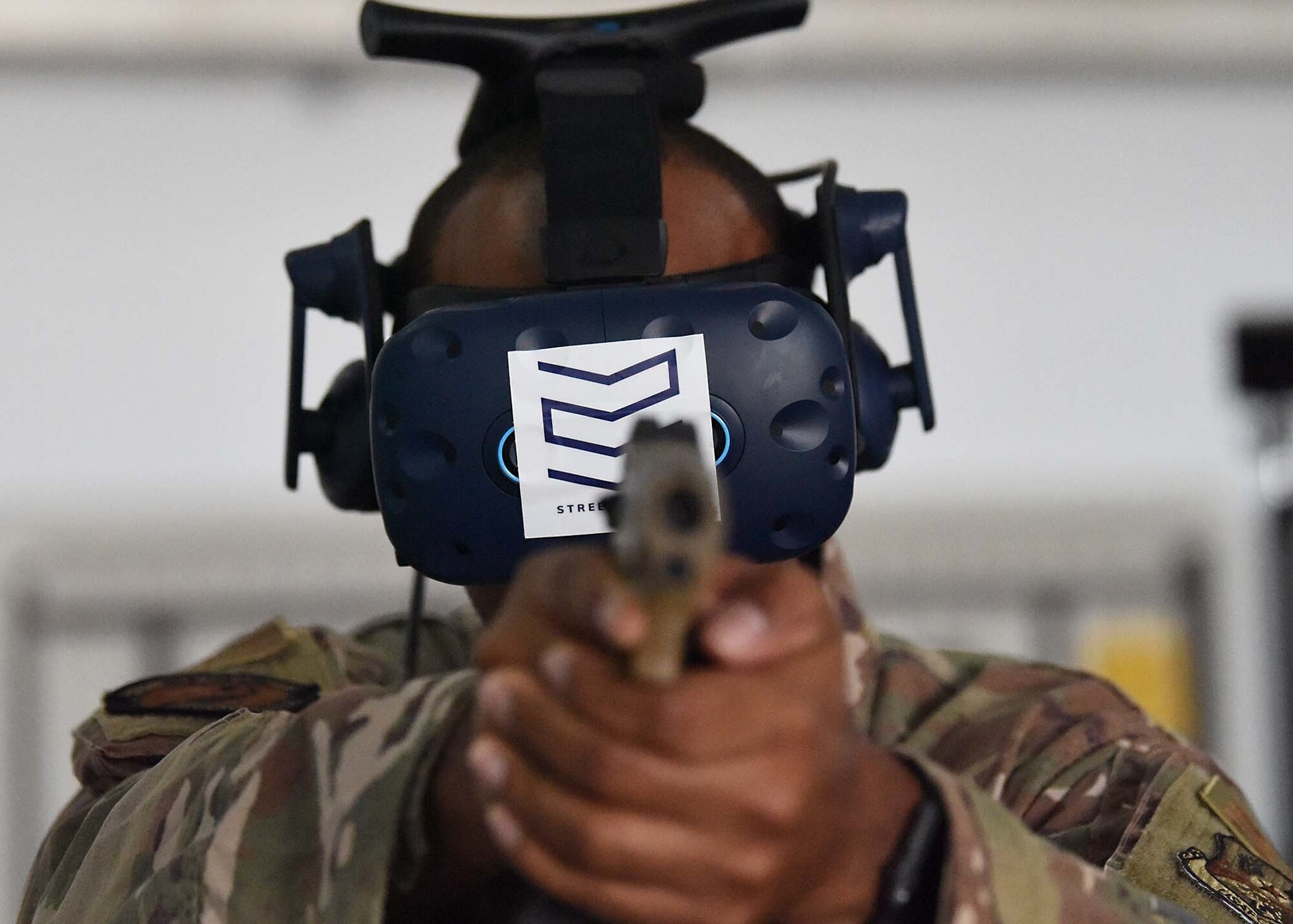 U.S. Air Force Master Sgt. Kenneth Greene, 380th Expeditionary Security Forces Squadron training NCO in charge, points a simulated M-18 while wearing a virtual reality (VR) system at Al Dhafra Air Base (ADAB), United Arab Emirates, Jan. 20, 2020.