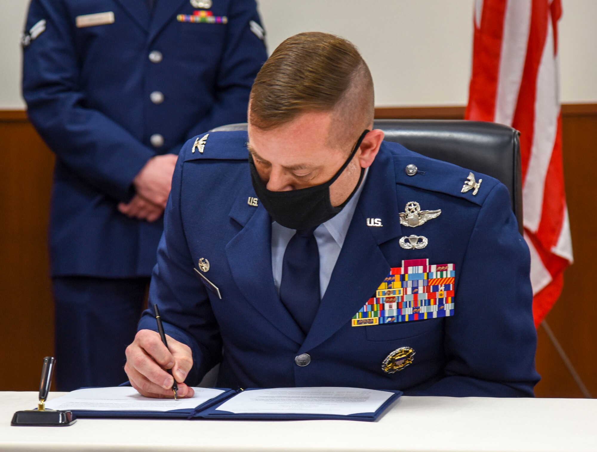 U.S. Air Force Col. Jesse J. Friedel, 35th Fighter Wing commander, signs the Memorandum of Understanding 3010 at Misawa Air Base, Japan, Feb. 12, 2021. The MOUI, which is the first of its kind to be signed in more than 20 years at Misawa, outlines the responsibilities associated with the joint or sole use, maintenance, repair, and construction of U.S. and Japanese owned facilities and areas on Misawa Air Base. (U.S. Air Force photo by Tech. Sgt. Timothy Moore)