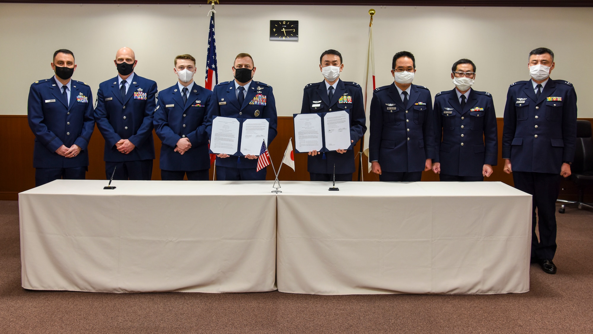 U.S. Air Force and Japan Air Self-Defense Force members pose for a photo with signed copies of the Memorandum of Understanding International 3010 at Misawa Air Base, Japan, Feb. 12, 2021. The first of its kind to be signed in more than 20 years at Misawa, MOUI 3010 outlines the responsibilities associated with the joint or sole use, maintenance, repair, and construction of U.S. and Japanese owned facilities and areas on Misawa Air Base. (U.S. Air Force photo by Tech. Sgt. Timothy Moore)