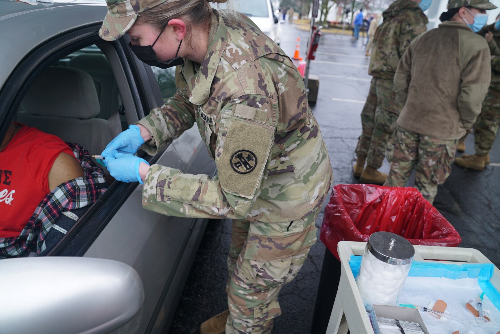 Ohio Army National Guard Spc. Amanda Heckman prepares to administer the COVID-19 vaccine to an Ohio resident as part of the state’s phased vaccination program Jan. 26, 2021, in Columbus. The Ohio National Guard is supporting the Ohio Department of Health, Ohio Department of Aging and several community partners.