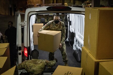 Soldiers from the Michigan National Guard’s Forward Support Company, 107th Engineer Battalion, based in Marquette, and the 177th Military Police Brigade, based in Taylor, join other Soldiers in food distribution at the U.S. Capitol Feb. 7, 2021. The National Guard is supporting law enforcement in the nation's capital through mid-March.