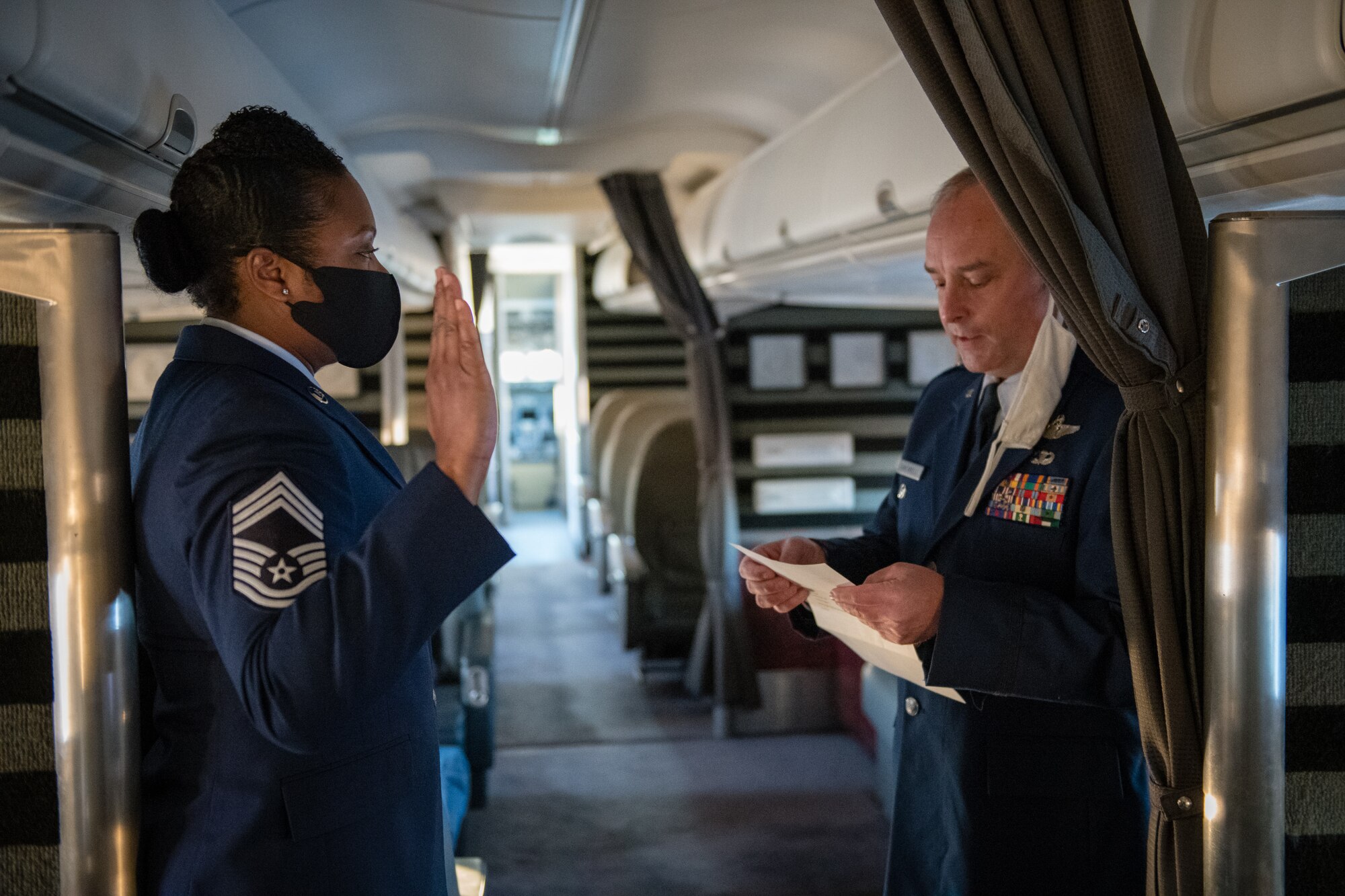 Chief Master Sgt. Monica Codner, 73rd Airlift Squadron superintendent, recites the oath of enlistment given by Lt. Col. David Santarelli, 932nd Airlift Wing deputy commander, during her promotion ceremony aboard a 932nd C-40C December 4, 2020, Scott Air Force Base, Illinois. (U.S. Air Force photo by Christopher Parr)
