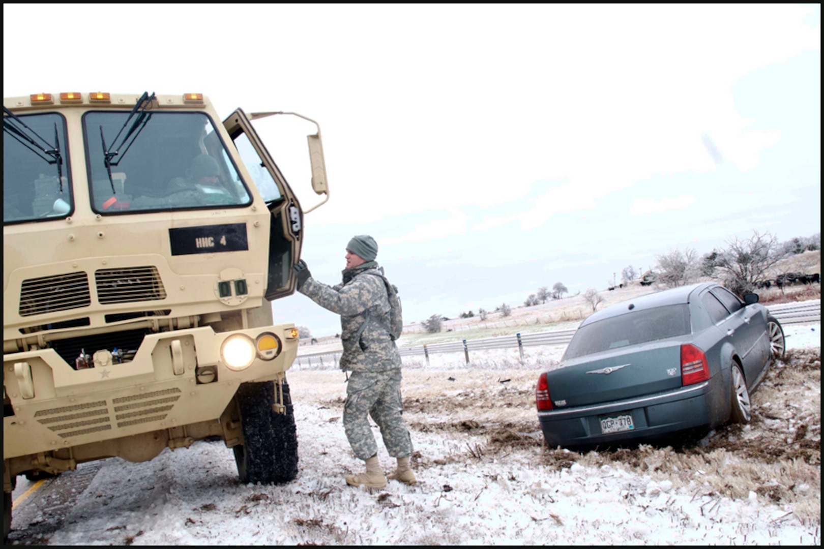 An Oklahoma Army National Guardsman prepares to check a vehicle for occupants, Dec. 28, 2015. (Oklahoma National Guard photo by Sgt. Anthony Jones)