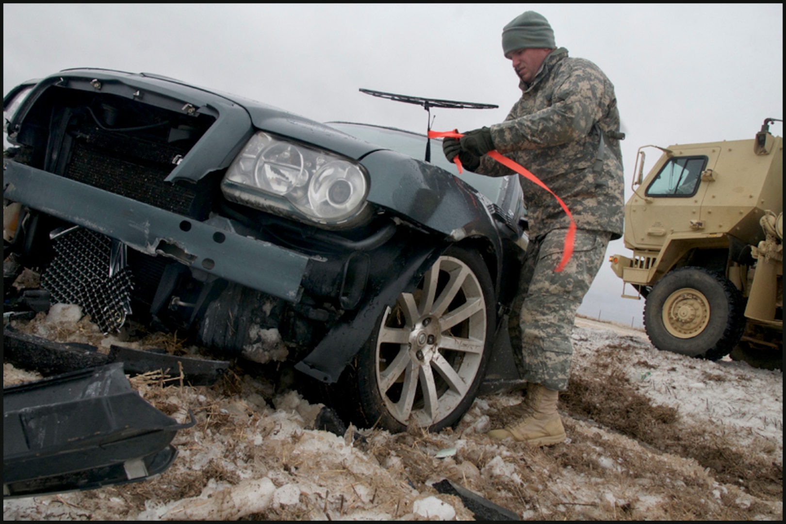 Sgt. Joseph English, of Newalla, Oklahoma, ties a fluorescent ribbon to a wrecked car, marking it as searched and clear of passengers while he and other Soldiers patrolled a section of Interstate 35 north of Perry, Okla., Dec. 28, 2015.

English, a military policeman with the 45th Brigade Special Troops Battalion, 45th Infantry Brigade Combat Team, and other Soldiers from the Brigade assisted the Oklahoma Highway Patrol with motorist assistance during a severe winter storm on Dec. 27 and 28. (Oklahoma National Guard photo by Sgt. Anthony Jones)