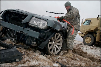 Sgt. Joseph English, of Newalla, Oklahoma, ties a fluorescent ribbon to a wrecked car, marking it as searched and clear of passengers while he and other Soldiers patrolled a section of Interstate 35 north of Perry, Okla., Dec. 28, 2015.

English, a military policeman with the 45th Brigade Special Troops Battalion, 45th Infantry Brigade Combat Team, and other Soldiers from the Brigade assisted the Oklahoma Highway Patrol with motorist assistance during a severe winter storm on Dec. 27 and 28. (Oklahoma National Guard photo by Sgt. Anthony Jones)