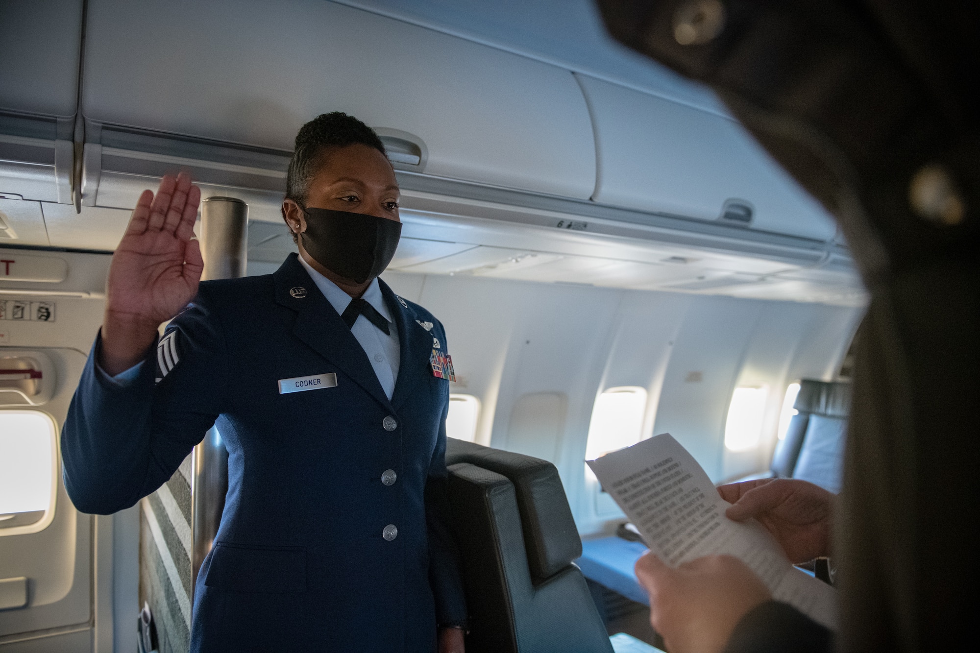 Chief Master Sgt. Monica Codner, 73rd Airlift Squadron superintendent, recites the oath of enlistment given by Lt. Col. David Santarelli, 932nd Airlift Wing deputy commander, during her promotion ceremony aboard a 932nd C-40C December 4, 2020, Scott Air Force Base, Illinois. (U.S. Air Force photo by Christopher Parr)