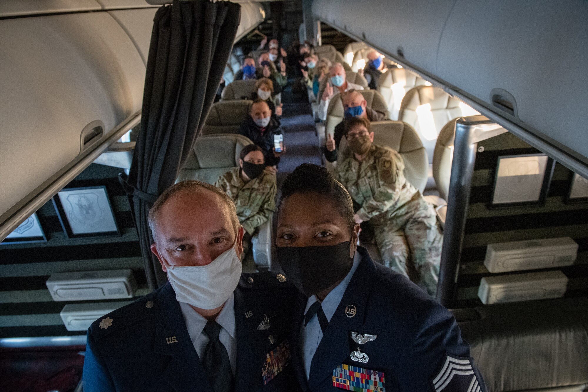 Chief Master Sgt. Monica Codner, 73rd Airlift Squadron superintendent, and  Lt. Col. David Santarelli, 932nd Airlift Wing deputy commander, pose for a photo with attendees after Codner’s promotion ceremony to Chief Master Sgt. aboard a 932nd AW C-40C December 4, 2020, Scott Air Force Base, Illinois. (U.S. Air Force photo by Christopher Parr)