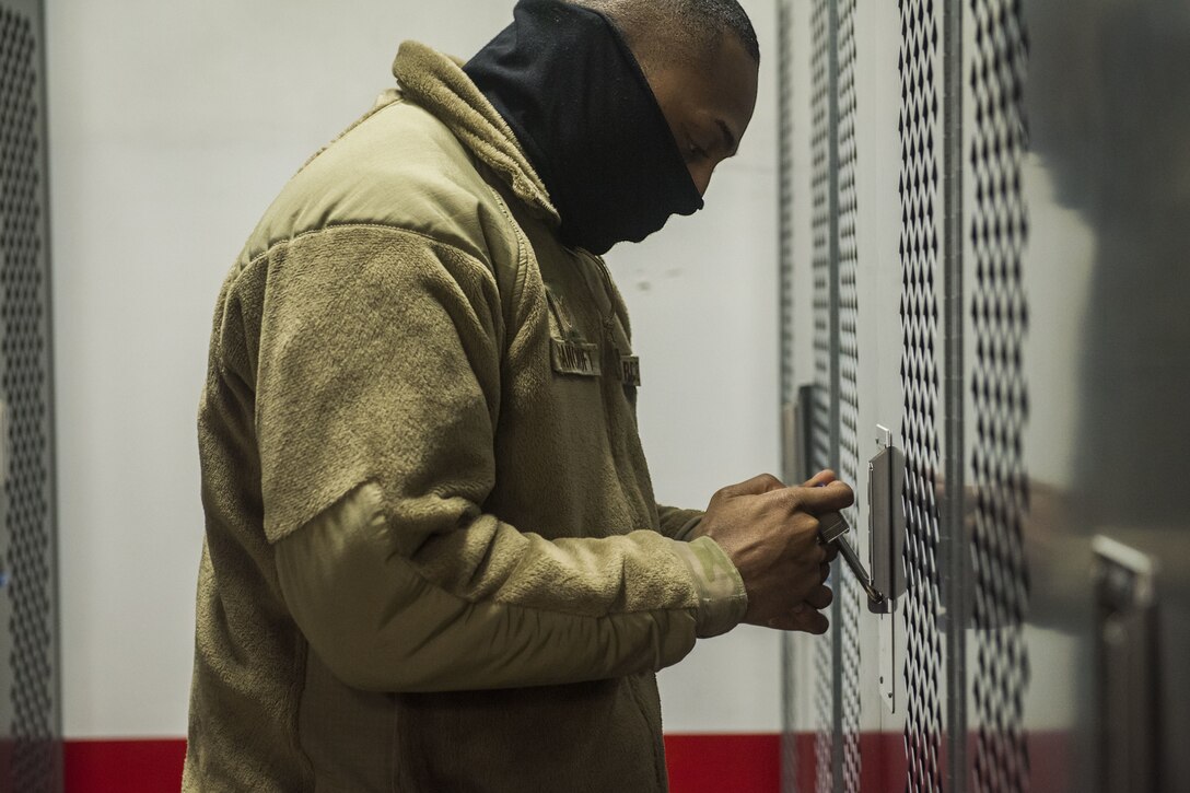 Man in uniform unlocking a storage facility